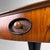 An elegant Italian side table that pairs warm wood veneer with a striking black pedestal base. Dimensions: height 60 cm,...
