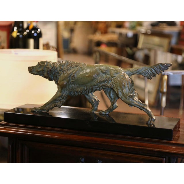The antique dog sculpture was created in France, circa 1880. Set on a rectangular black marble base, the work features an...