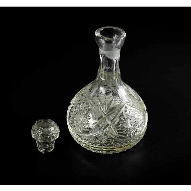 Glass liquor bottle is an original decorative object realized in the 1970s. A beautiful glass little bottle with topper...