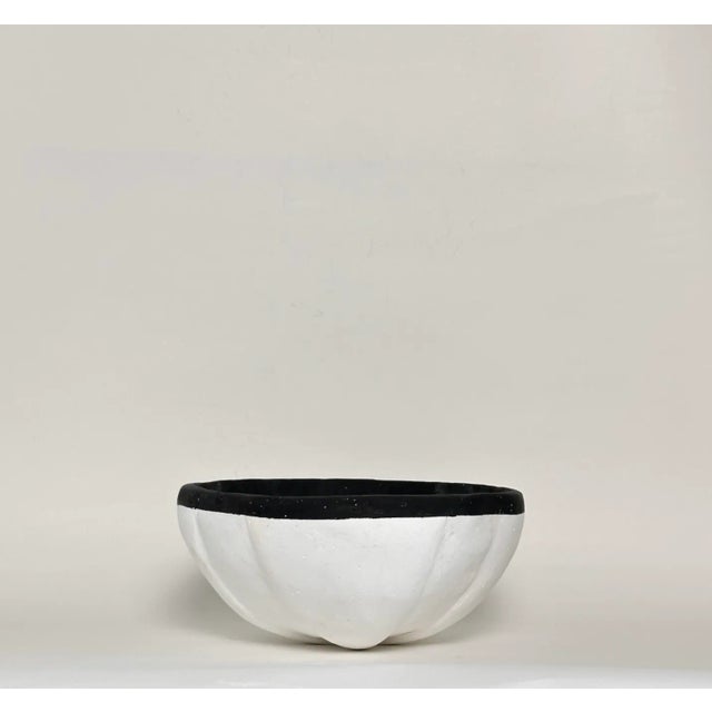 A bold meditation in contrast, this bowl merges tactile imperfection with architectural elegance. Carved with intention,...