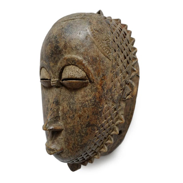 Vintage Baule mask from West Africa region. Traditional detailed carving and designs. Ready to hang as wall art on its own...