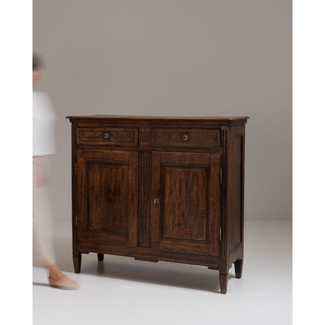 This 19th century Renaissance buffet in original patina from France is made in dark wood with two paneled doors above a...