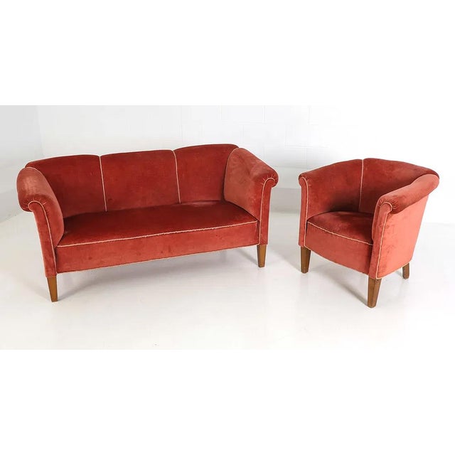 An earlier Danish Mid Century Modern sofa and matching lounge chair. The set is upholstered in a ribbed velvet/velour...