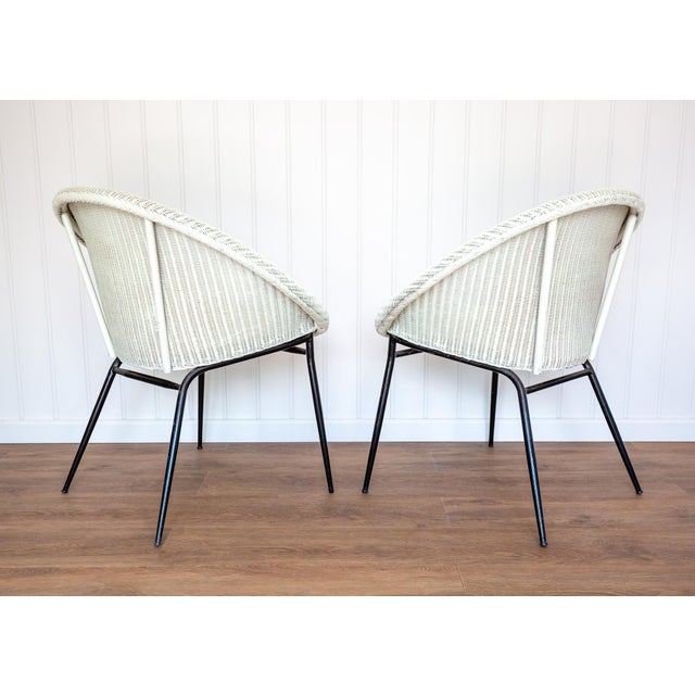 A strikingly attractive and rare pair of mid-century satellite cocktail chairs in lovely vintage condition. Made by the...