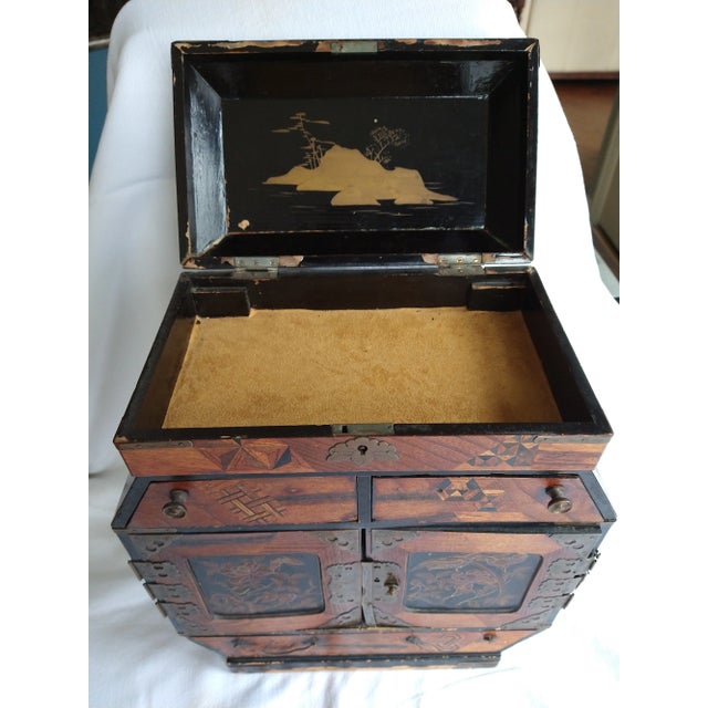 Antique Chinese Jewelry Box with beautiful detailed inlays and brass mountings. It features 3 drawers and 2 doors that...