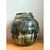 This vintage ceramic vessel takes a substantial, bulbous form, its rounded body swelling outward before narrowing to a...