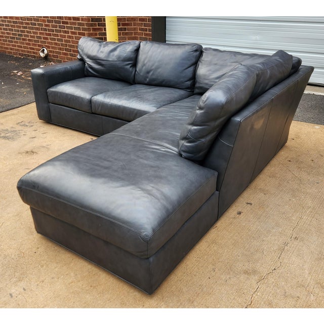 A generously scaled two-piece leather sectional from Century Furniture, designed with plush seating, and the refined...