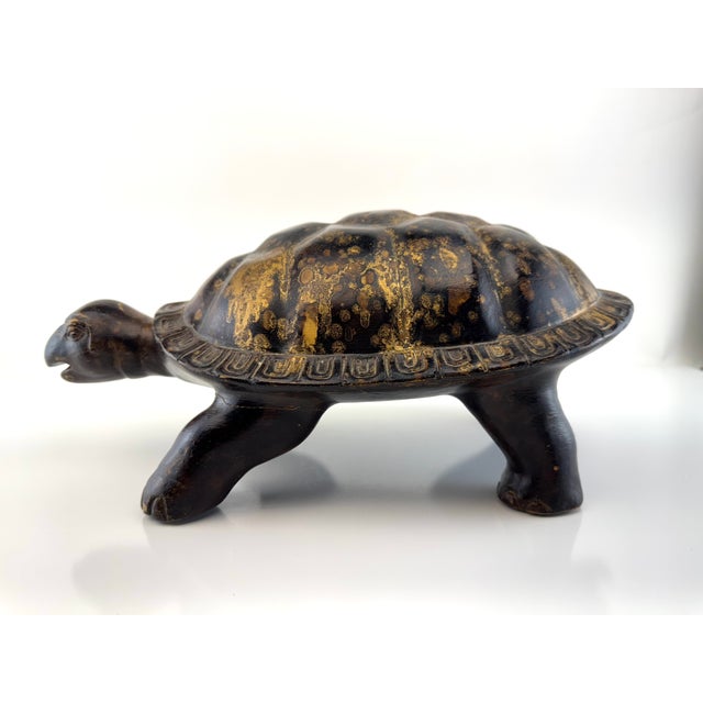 A sculptural vintage tortoise rendered in a richly textured gilt-over-dark finish, giving the surface a beautifully...