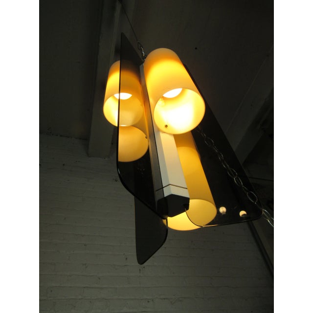 A unique geometric pendant with three lights and tinted panels. Suspended by an adjustable hanging fixture, this vintage...
