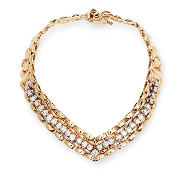 Stylish vintage diamond "V" bracelet crafted in 14 karat yellow gold (circa 1980s). Diamonds total an estimated 1.11...
