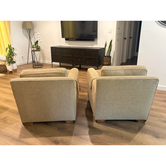 Zoffany Tan upholstered club chairs, wood feet with matching ottomans and arm covers. Down and feather filled cushions....