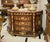 Make an unforgettable statement with this Monumental French Empire Bombe Commode, an extraordinary masterpiece that blends...