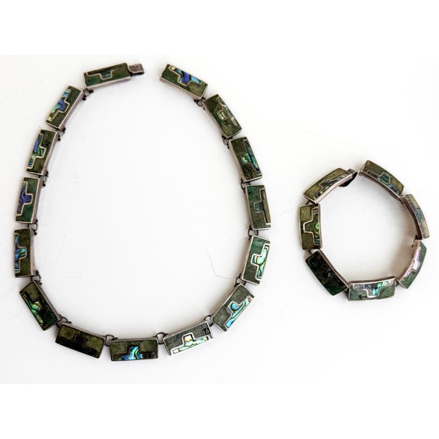This stunning set includes a matching necklace and bracelet, made of sterling silver and inlaid with turquoise and abalone...