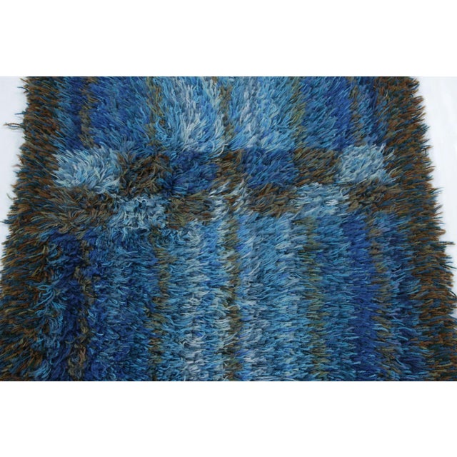 Hand-knotted in lush, high-pile wool in Sweden circa 1960-1970, this 2x4 vintage Swedish Rya rug is a bold new addition to...