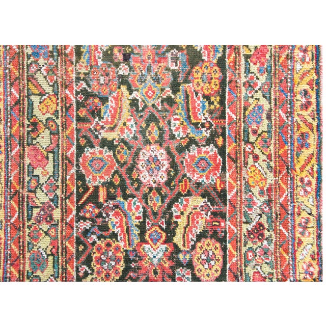 A wonderful early 20th century Persian Kurdish rug with an all-over floral trellis pattern with large flowers and leaves...