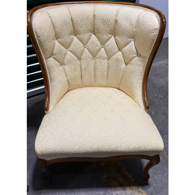 This is a matching pair of elegant antique style slipper chairs. These armless accent chairs are upholstered in a light...