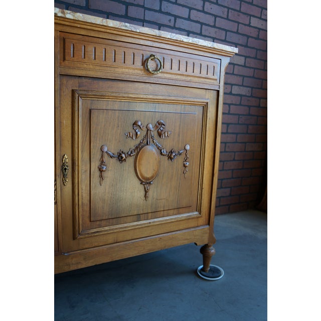 French antique Louis XVI Style walnut marble top sideboard. Versatile storage with two drawers over two doors. Oh so...