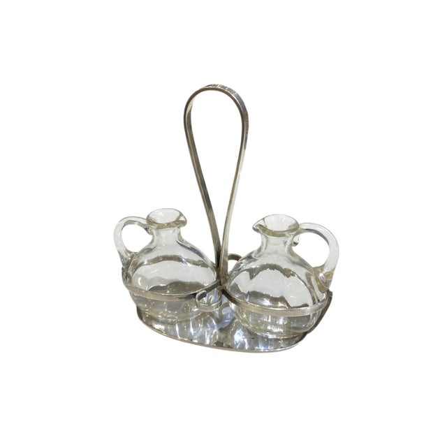 A beautiful oil-and-vinegar cruet set from Arthur Krupp Milano. The set includes two clear hand-blown glass cruets with...