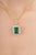 This halo enhancer pendant features a 9.95-carat emerald-cut green emerald, set in 14k yellow gold. The center stone...