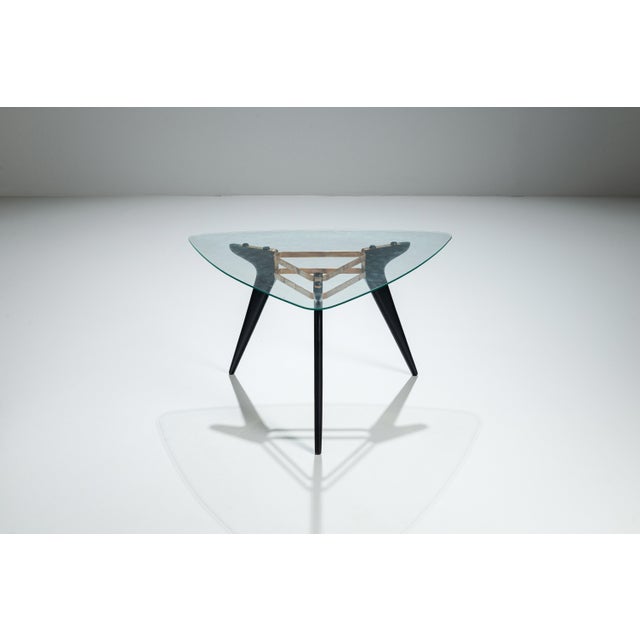 This vintage triangular coffee table is a striking example of mid-century design, where sculptural form and material...