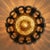 An Italian sconce from the 1970s, defined by its verdigris iron frame and molten amber glass dome. The hand-wrought iron...