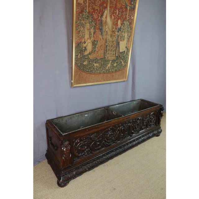 A renaissance-style planter in carved walnut, featuring heraldic lions and two zinc liners. A beautiful carving adorns the...