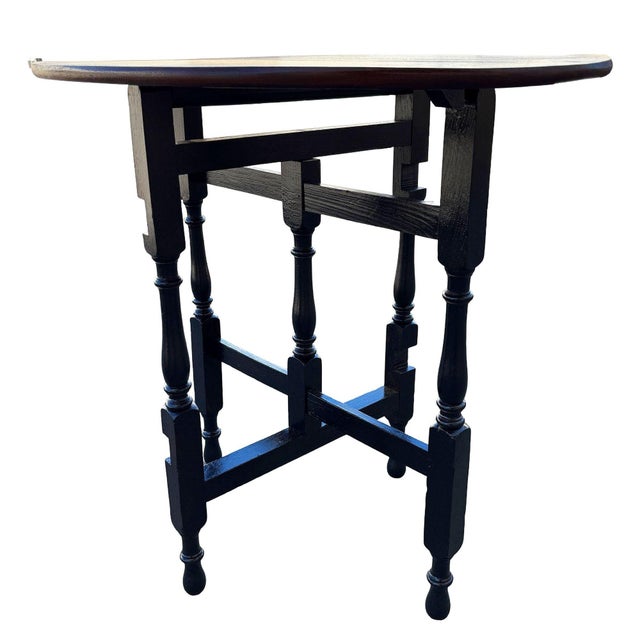Victorian era drop-leaf gate-leg oak table, with oval top and turned carved legs. Created in England during the Late 19th...