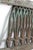 Bronze wall grate with ornate details in a rectangular frame. Some of the ornate pieces are missing. The original mounting...