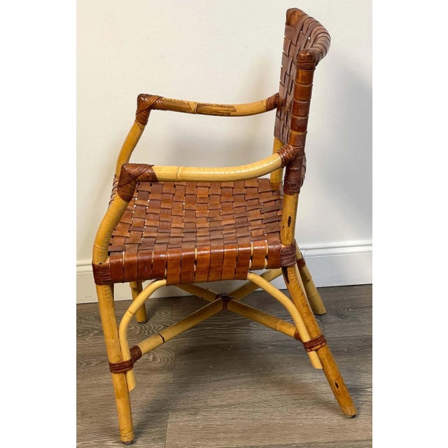 French modern bamboo & woven saddle leather armchair, France, Circa 1960s A unique beautiful model, well cared for this...