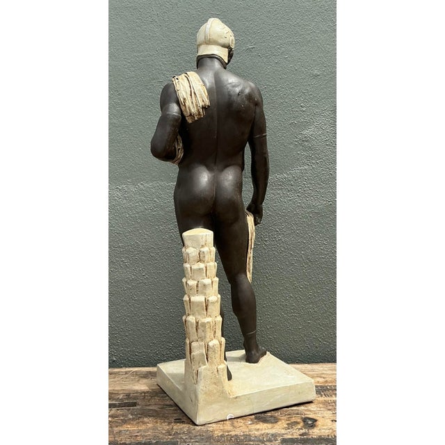 This commanding vintage sculpture captures the athletic nobility of classical antiquity, rendering a Greek warrior in a...