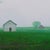 In "Spring Morning," a serene rural landscape unfolds, featuring a cluster of weathered barns set against a misty...