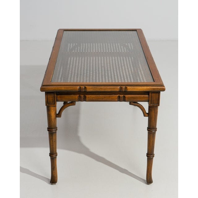 Executed in France circa 1970, this refined coffee table exemplifies the enduring appeal of the Hollywood Regency...