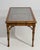Executed in France circa 1970, this refined coffee table exemplifies the enduring appeal of the Hollywood Regency...