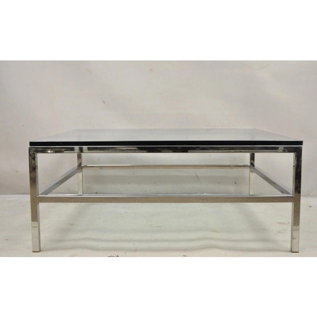 Vintage Mid Century Modern Milo Baughman Style Chrome & Glass Square Coffee Table. Item features a thick square glass top,...