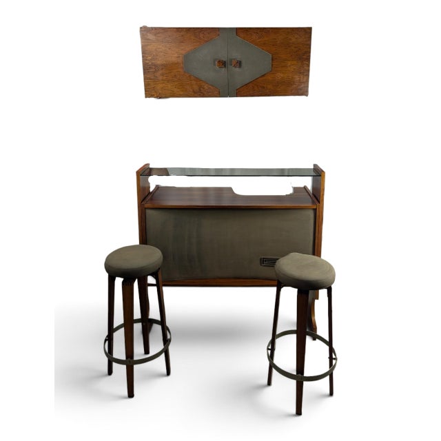 Vintage bar unit consisting of a main cabinet and a matching wall cabinet, with two stools. The cabinet is made of teak...