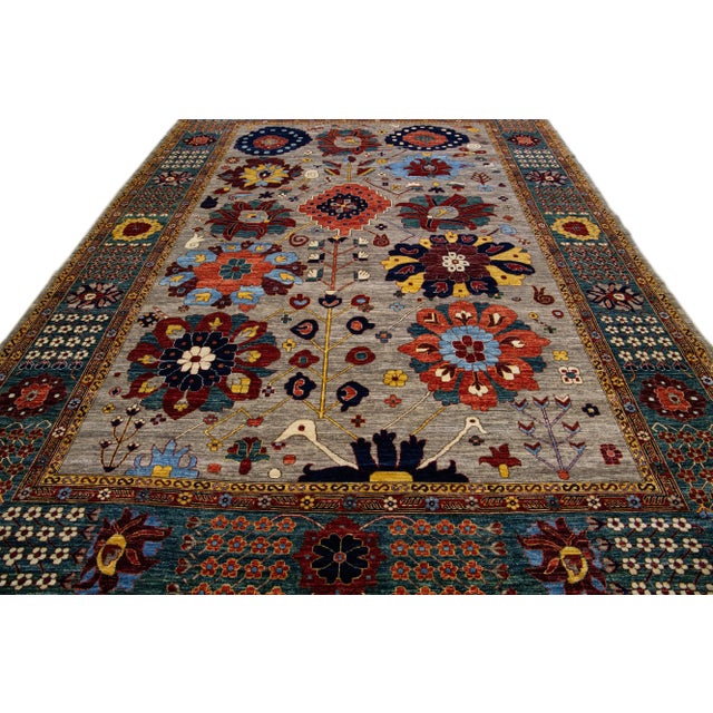 Beautiful antique Serapi style hand-knotted wool rug with a gray field. This piece has a green-designed frame and an all-...