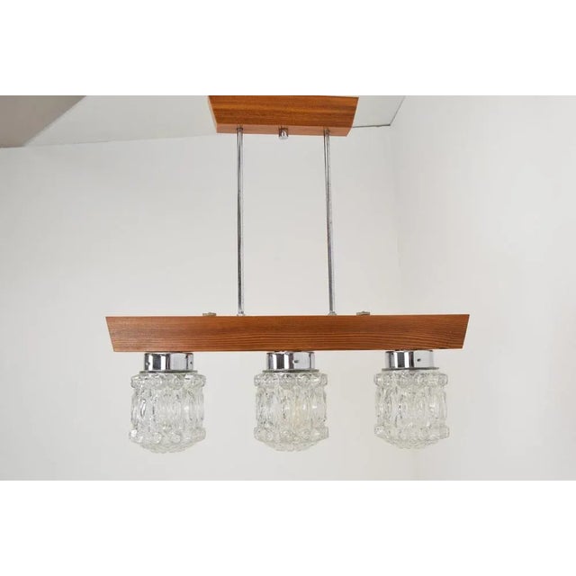 Made in Czechoslovakia. Made of glass, wood, metal. 3xE27 or E26 bulb. Original condition. This piece is attributed to the...