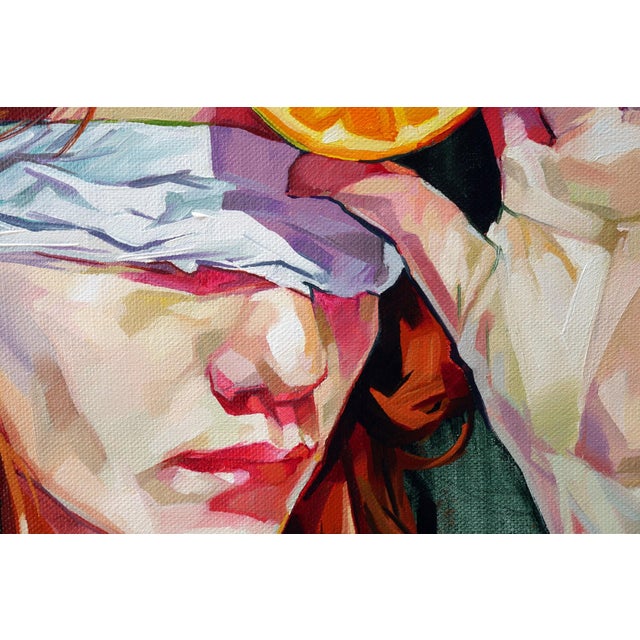The artwork features a figure with vibrant red hair, blindfolded and holding a halved orange against their forehead. The...