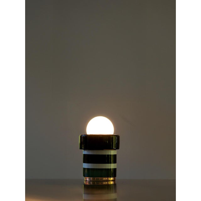A Parisian Lighthouse in Miniature with its compact proportions and understated silhouette, this lamp pays homage to the...