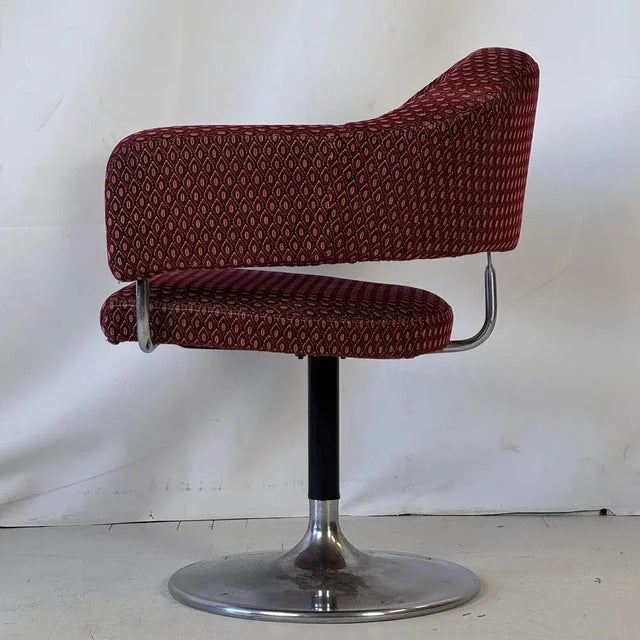 Unique Space Age armchair from the 1960s, featuring a sleek steel swivel base and bold futuristic form. The chair remains...
