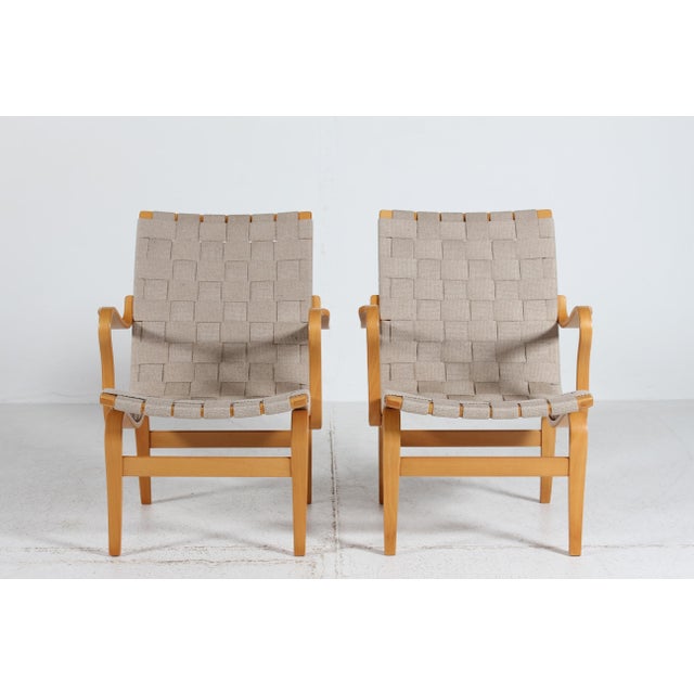 A pair of Scandinavian modern easy chairs and lounge chairs model Eva low version manufactured by Dux of Sweden. Designed...