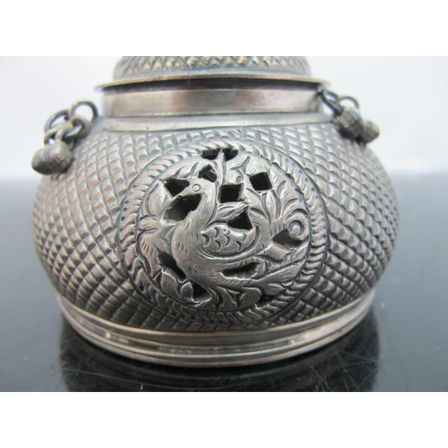 Southeast Asian silver betel nut box or incense burner with lid. Intricate openwork metal serves an essential dual...