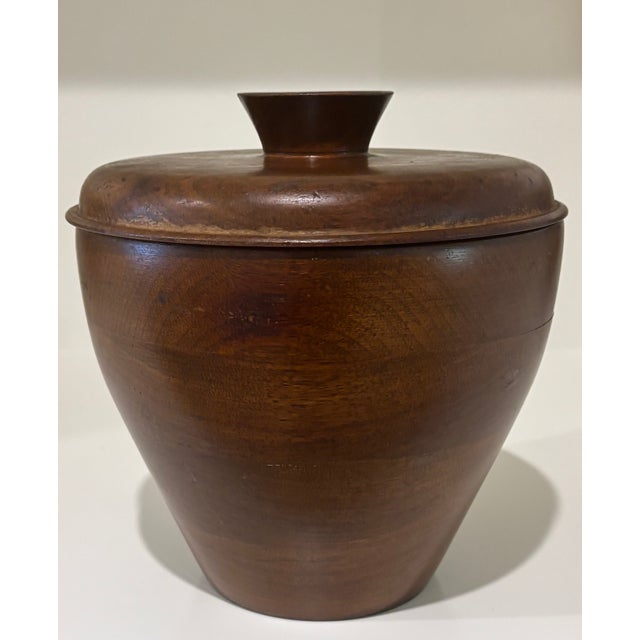 A beautifully crafted Scandinavian Modern teak ice bucket with fitted domed lid, cup-form finial and original opal glass...