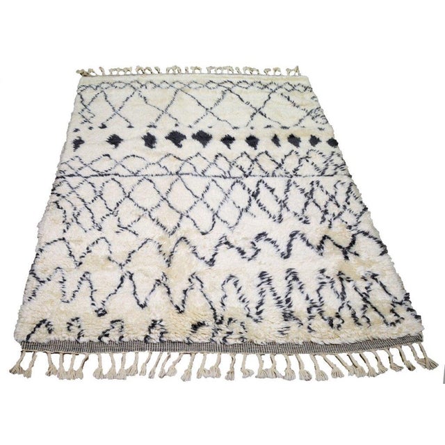 Hand-knotted with care using traditional rug making techniques, this wool rug blends timeless craftsmanship with a modern...