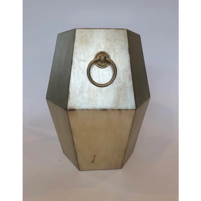 Designed in California, this Bliss Studio unique geometric-shaped, burnished gold-finished side table with antiqued...