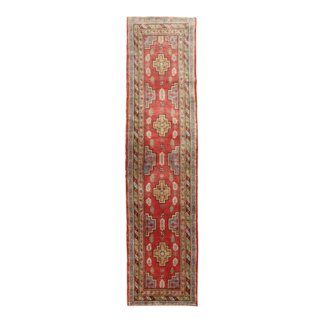 Antique Khotan Runner From Turkestan With Geometric Medallions in Red Background For Sale