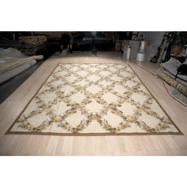 Vintage Aubusson with an all-over trellis of grape vines. Garlands of gold, brown and olive leaves with blue grape...