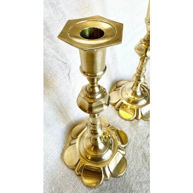 This gorgeous pair of George II petal-base brass candlesticks will make a lovely addition to any home. Brass is an alloy...