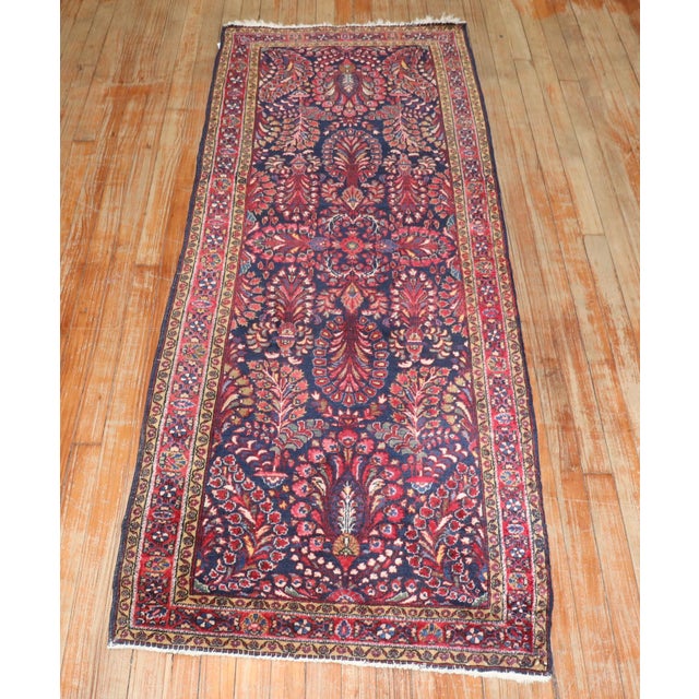 1920s Persian Sarouk small runner with a navy ground and floral design 2'6'' x 6'6'' .