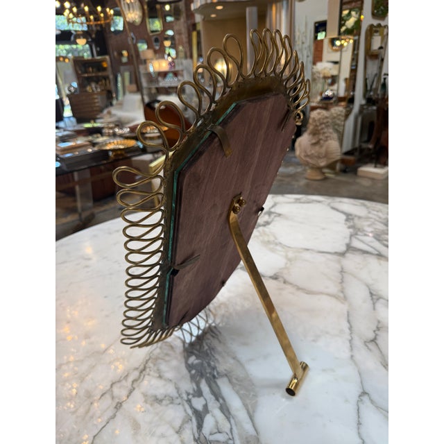Striking vintage tabletop or vanity mirror featuring an octagonal mirror plate surrounded by an ornate handcrafted brass...